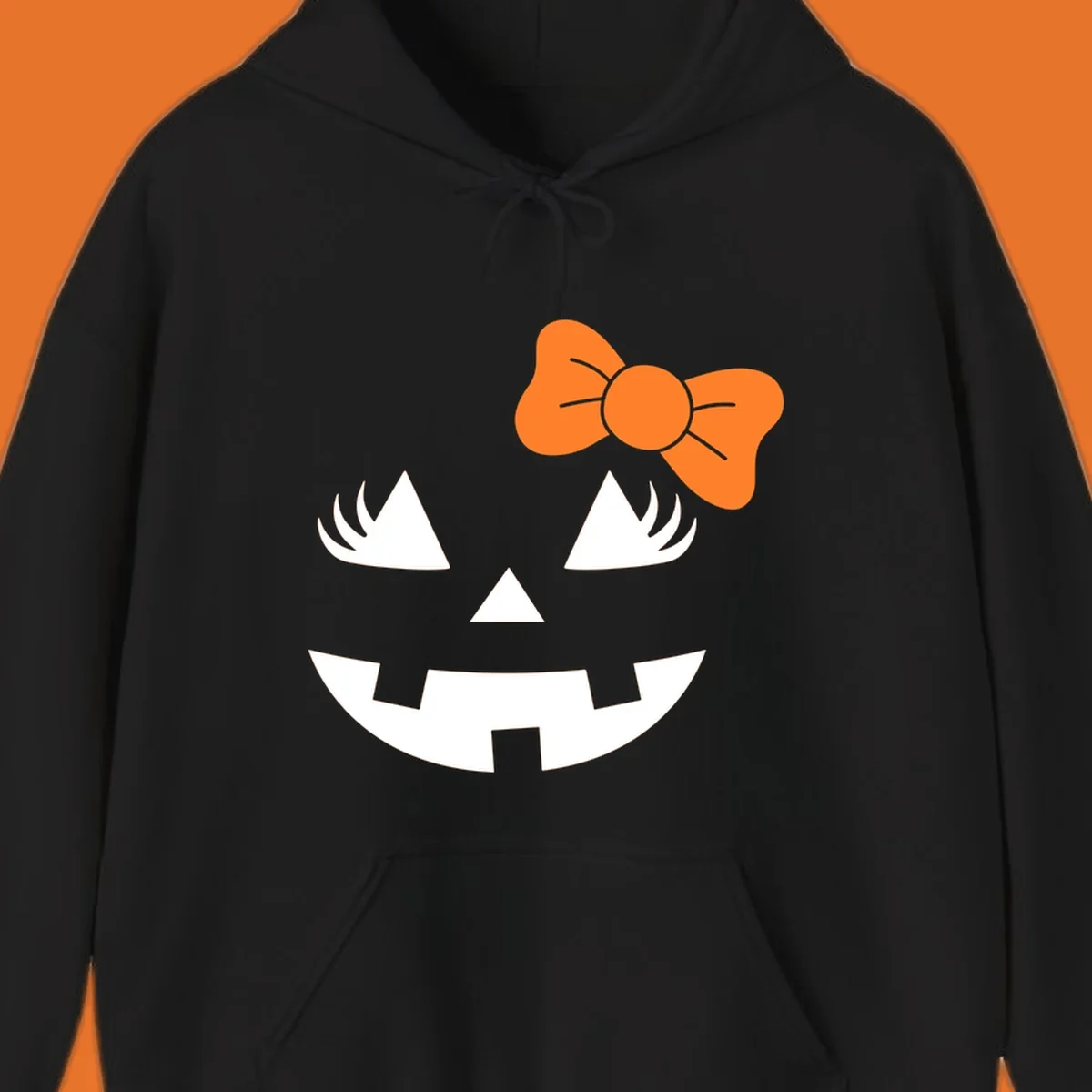 Cute halloween pumpkin face with an orange bow graphic