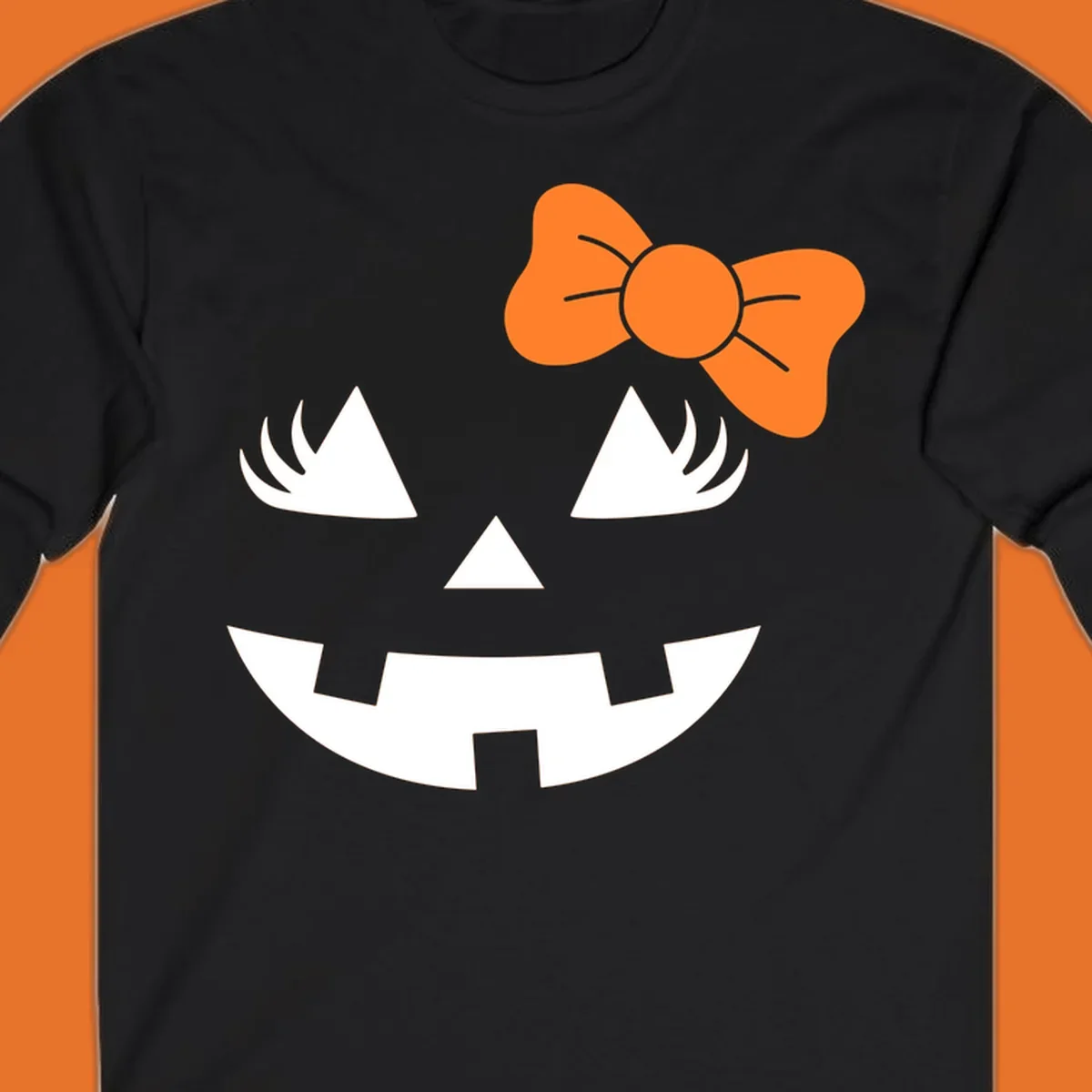 Cute halloween pumpkin face with an orange bow graphic