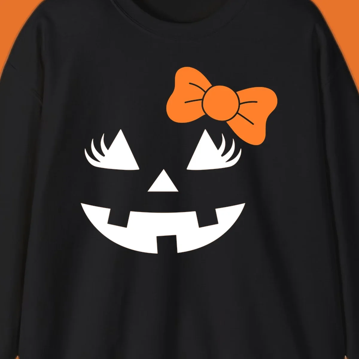 Cute halloween pumpkin face with an orange bow graphic