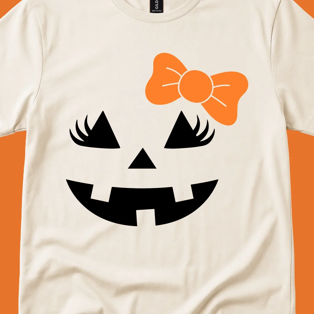 Cute halloween pumpkin face with an orange bow graphic