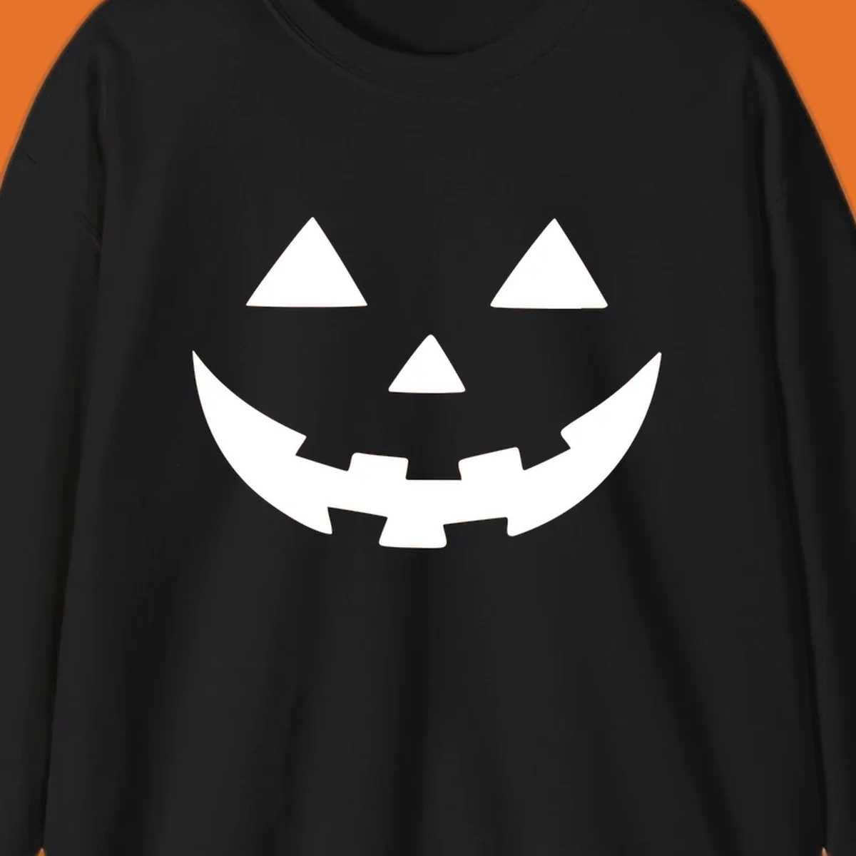 Classic jack o lantern face graphic with triangle eyes and jagged smile.