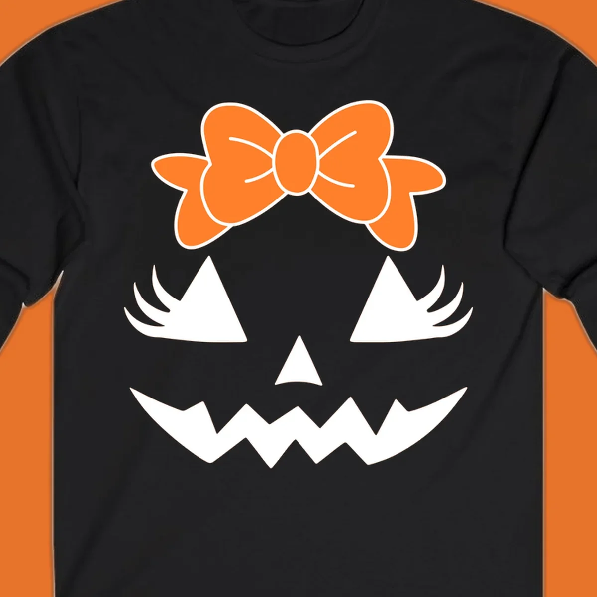 Cute pumpkin face graphic with orange bow, triangle eyes, nose, and jagged smile.