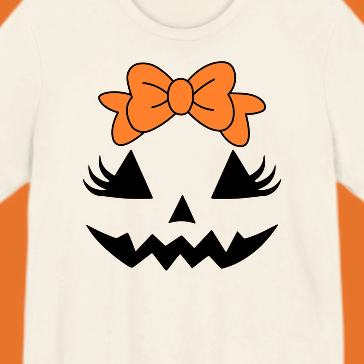 Cute pumpkin face graphic with orange bow, triangle eyes, nose, and jagged smile.