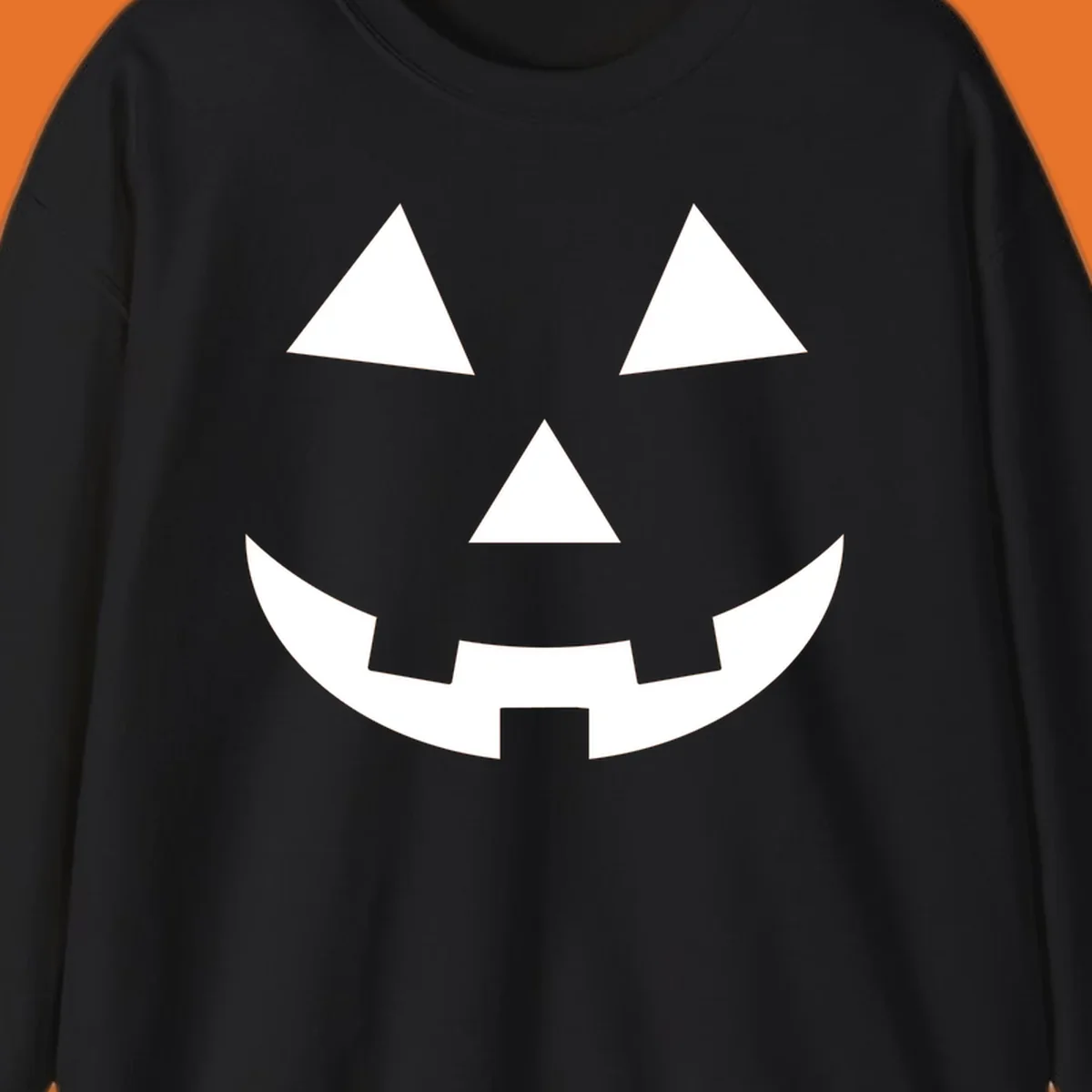 Classic jack o lantern face graphic with triangle eyes and jagged smile. Halloween design.