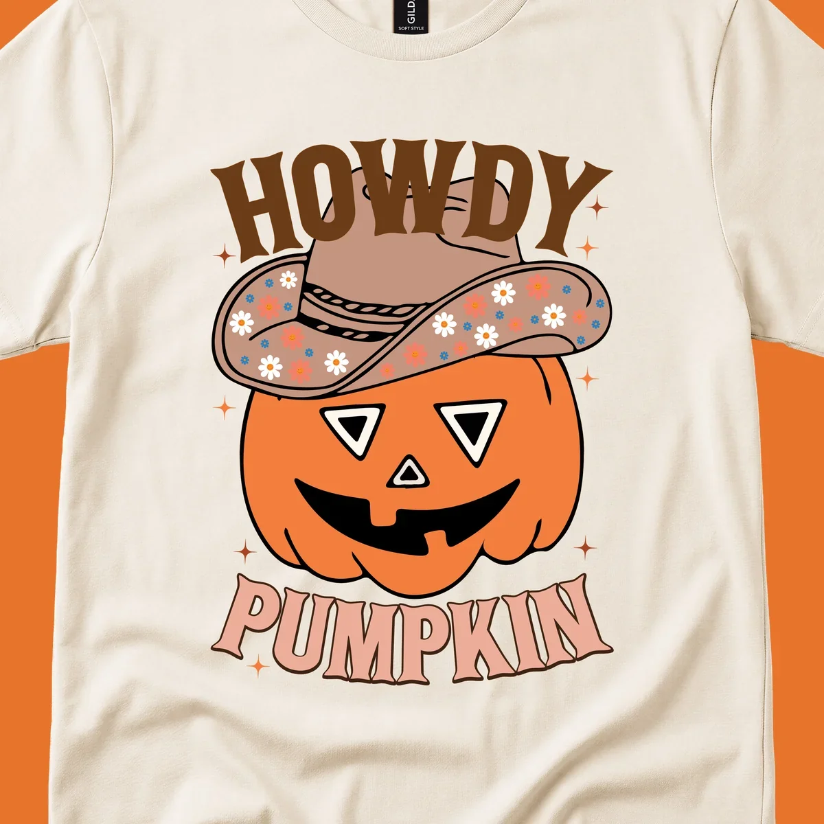 Howdy Pumpkin cowboy hat illustration for Halloween, with retro-style text and floral accents.