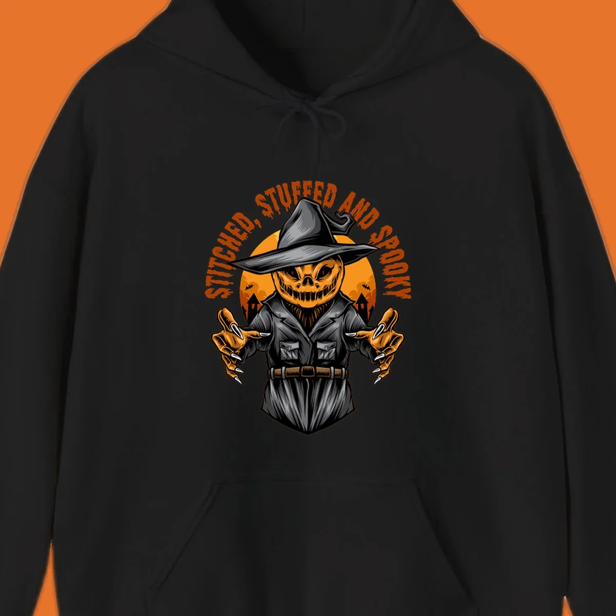 Spooky pumpkin character in a witch hat and suit, text reads STITCHED, STUFFED AND SPOOKY.