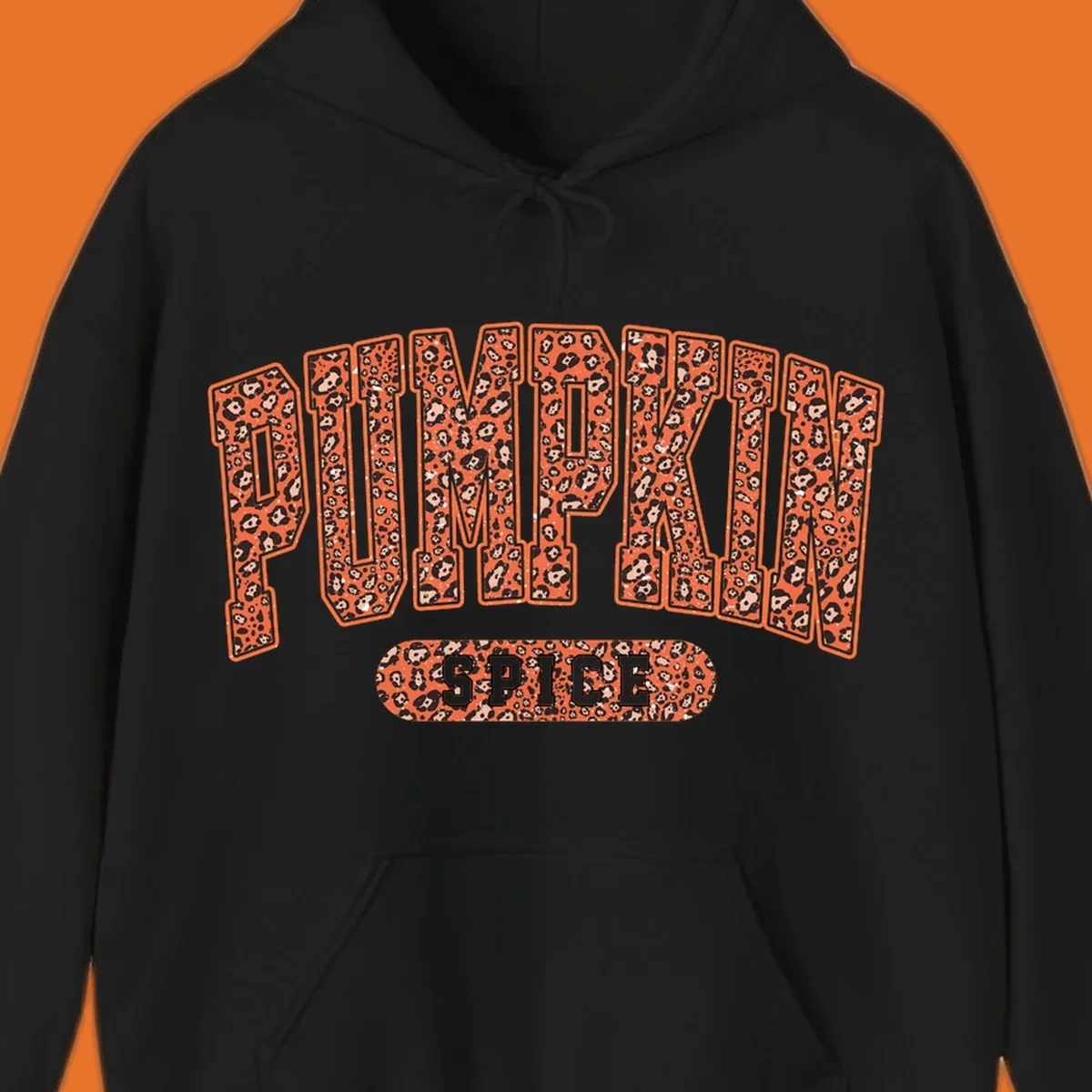 Pumpkin Spice text with leopard print pattern on dark outline, on black background.