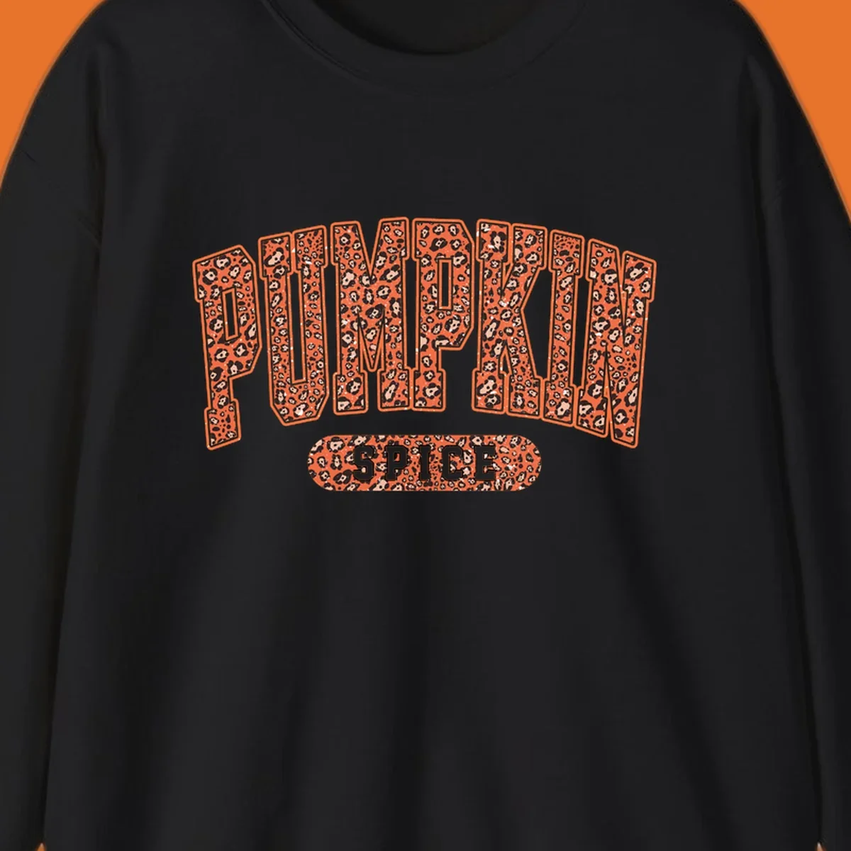 Pumpkin Spice text with leopard print pattern on dark outline, on black background.