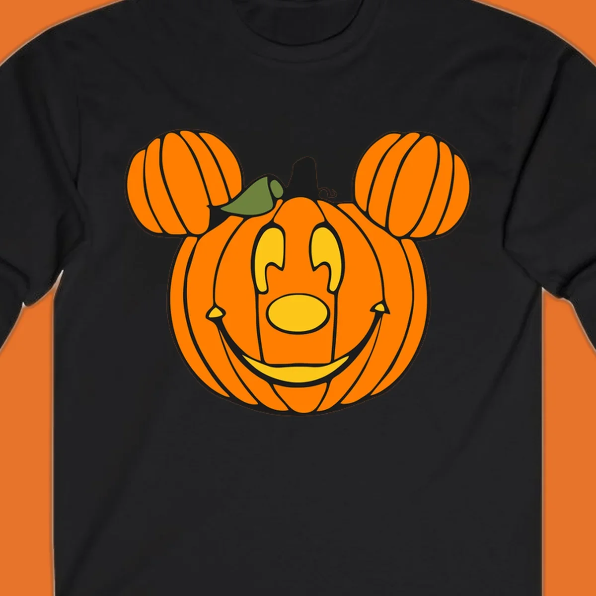 Mickey pumpkin halloween jack-o-lantern graphic with smiling face and ears.
