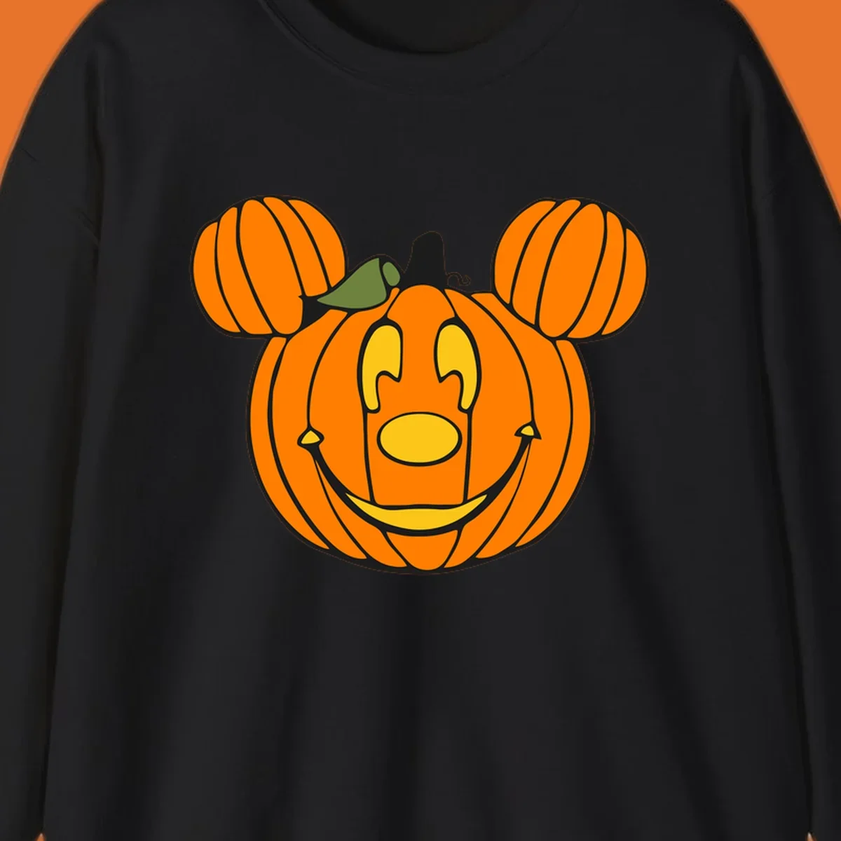 Mickey pumpkin halloween jack-o-lantern graphic with smiling face and ears.
