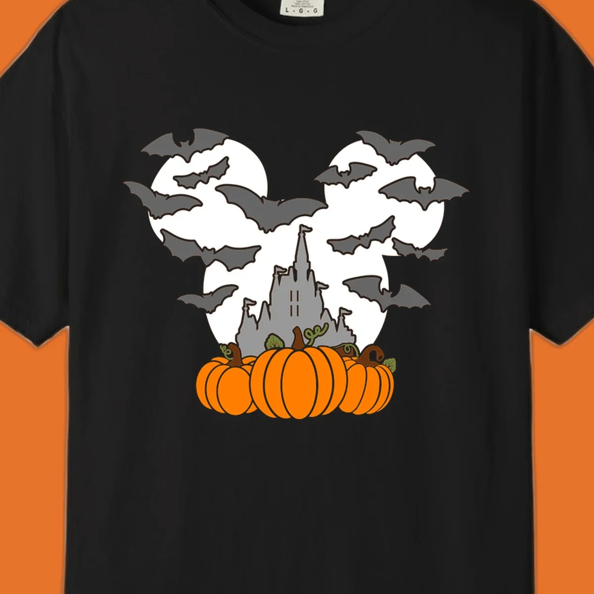 Halloween castle with bats and pumpkins against a Mickey Mouse ears moon graphic.