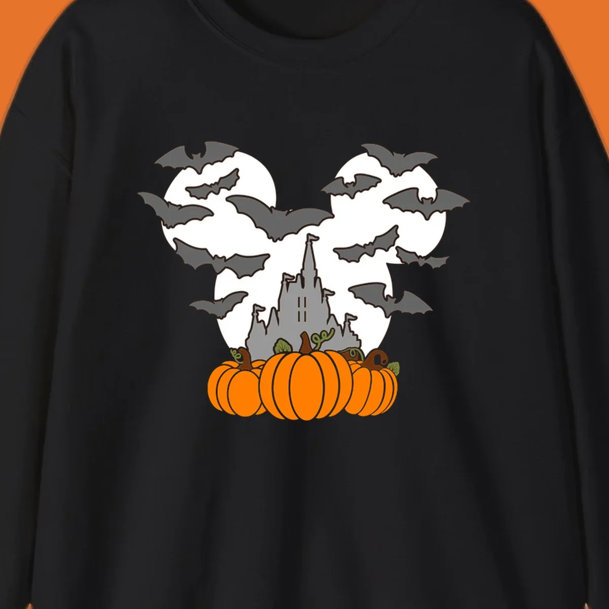 Halloween castle with bats and pumpkins against a Mickey Mouse ears moon graphic.