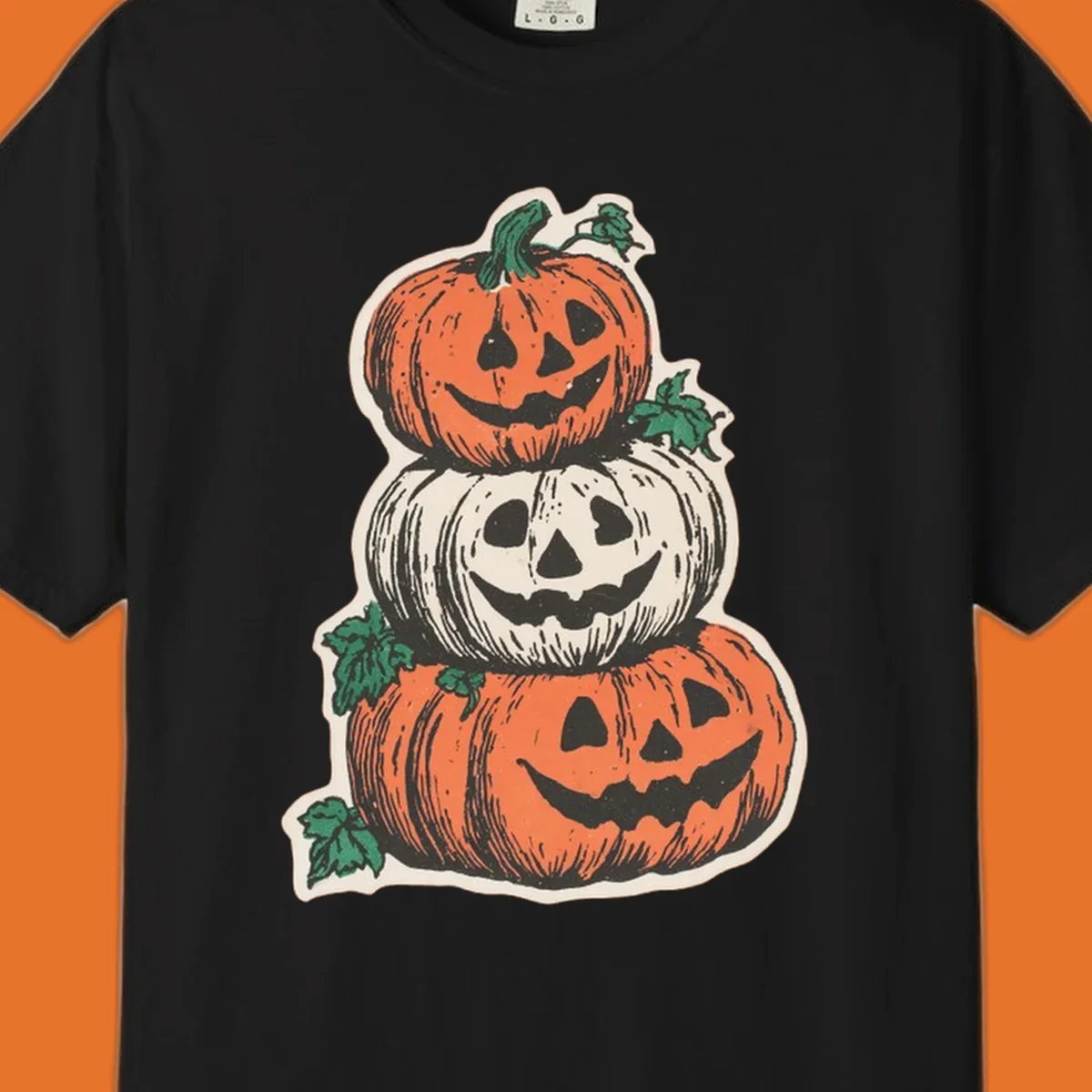 Stacked Halloween jack-o'-lanterns graphic with leaves for fall holiday shirts.