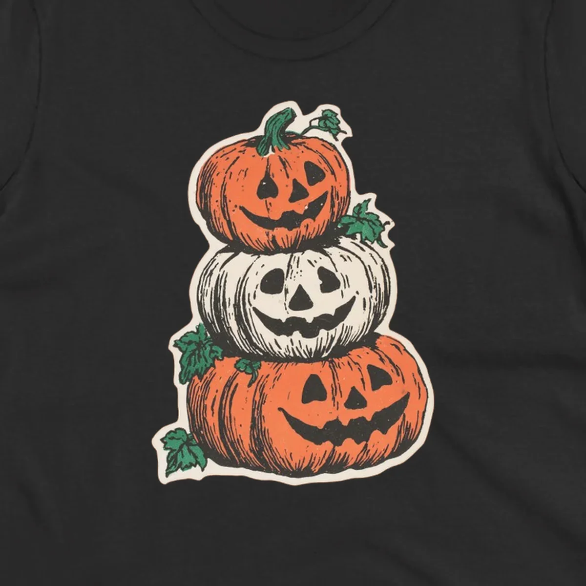 Stacked Halloween jack-o'-lanterns graphic with leaves for fall holiday shirts.