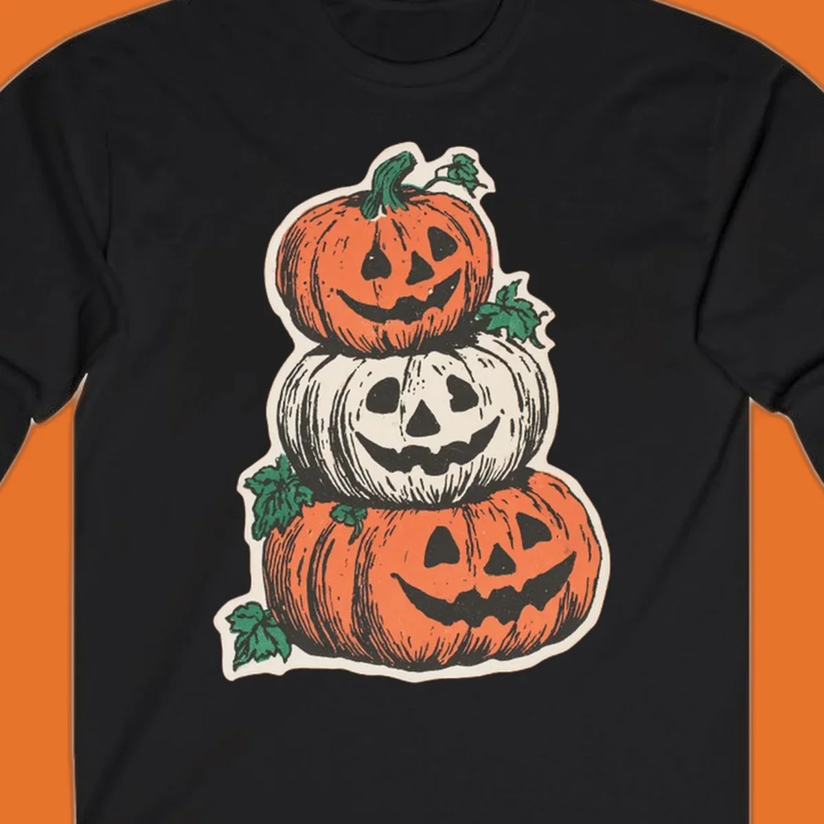 Stacked Halloween jack-o'-lanterns graphic with leaves for fall holiday shirts.