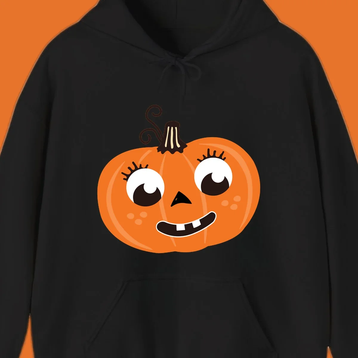 Cute halloween pumpkin face graphic with big eyes and a smile.