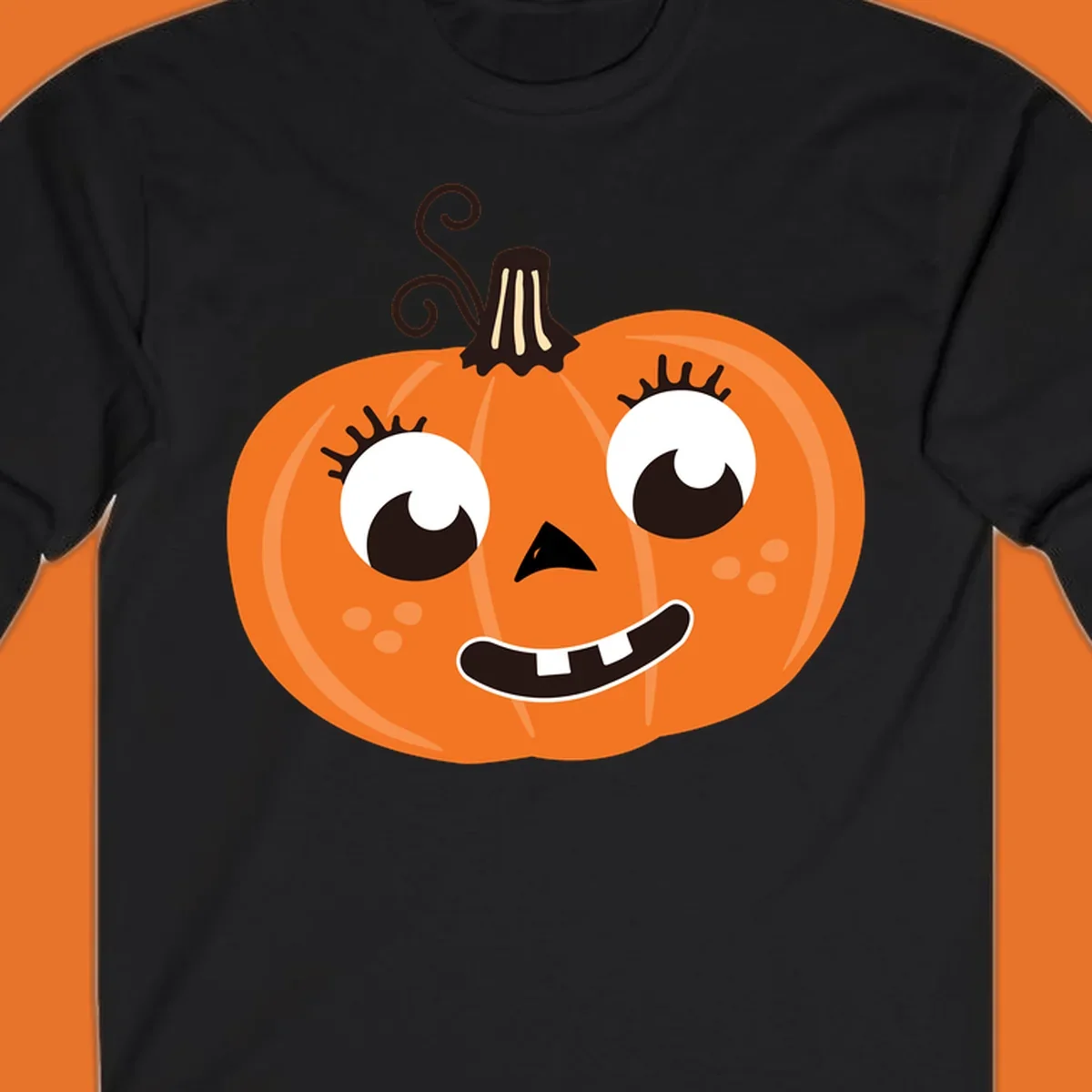 Cute halloween pumpkin face graphic with big eyes and a smile.