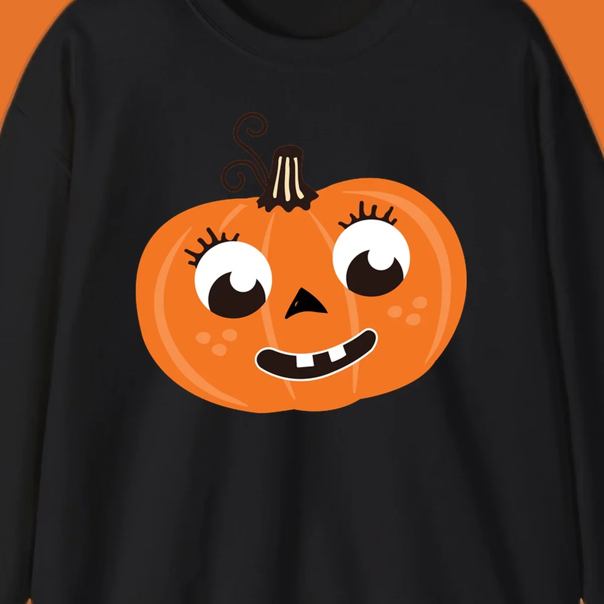 Cute halloween pumpkin face graphic with big eyes and a smile.