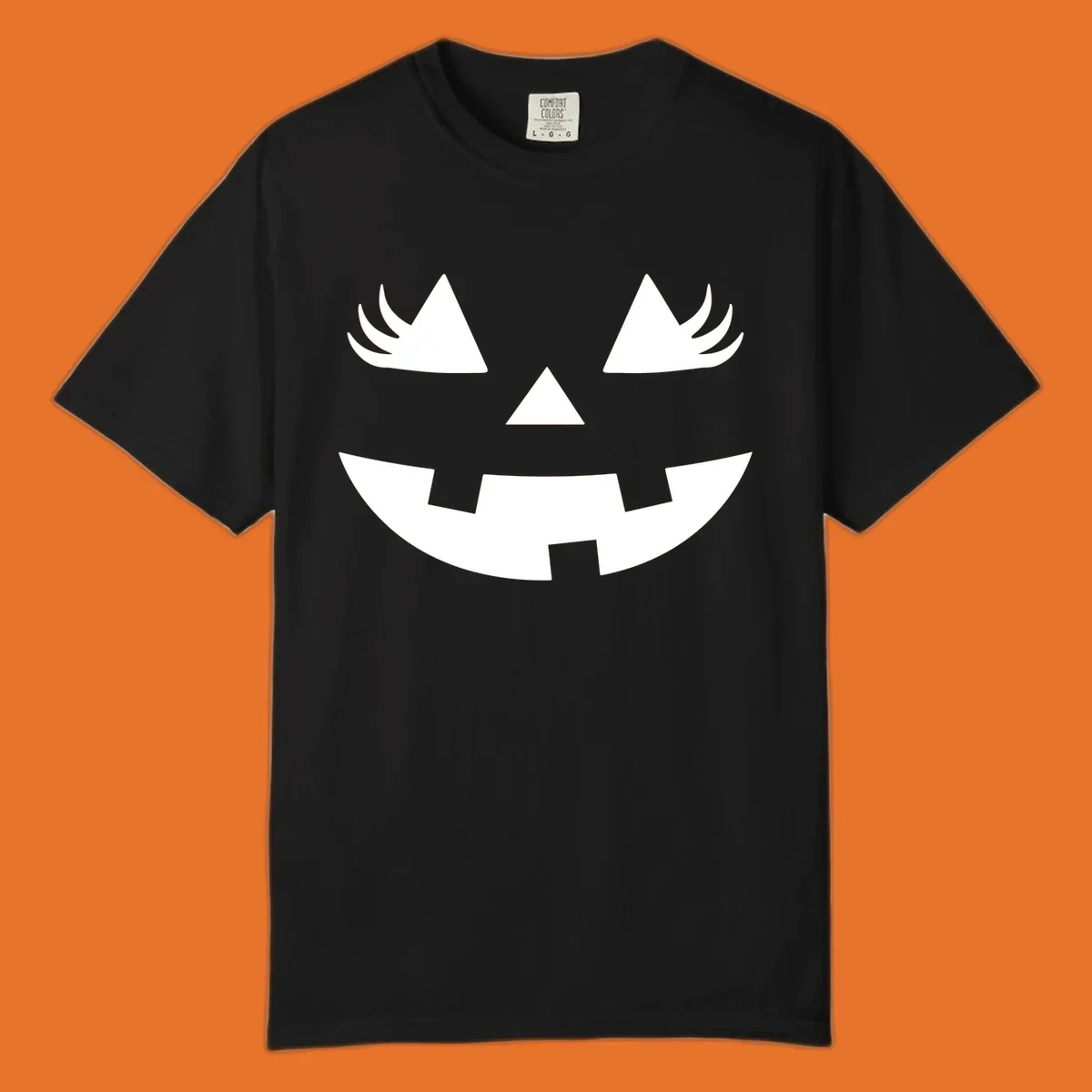 Jack o' lantern face with triangle eyes, nose, and jagged smile, featuring eyelashes.
