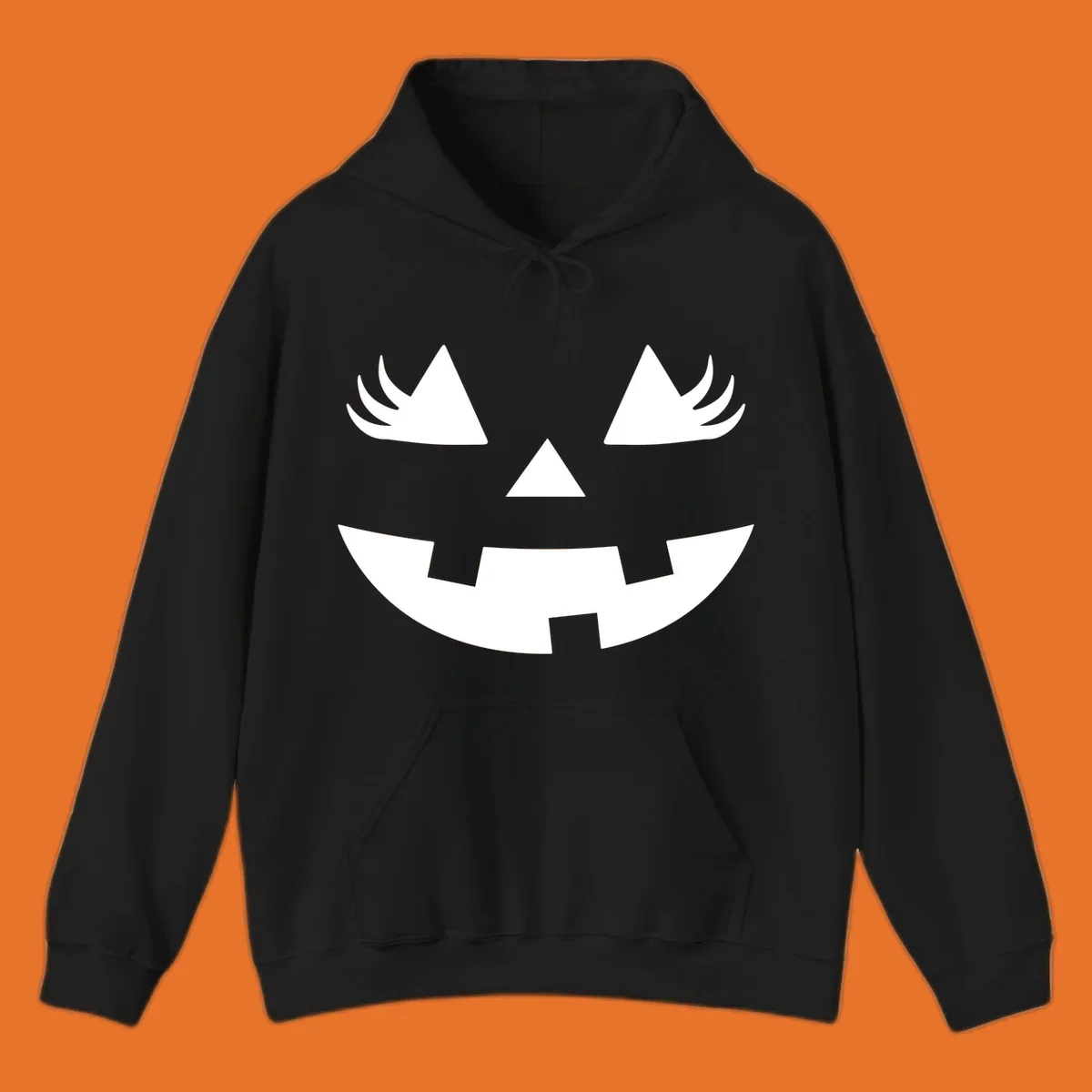 Jack o' lantern face with triangle eyes, nose, and jagged smile, featuring eyelashes.