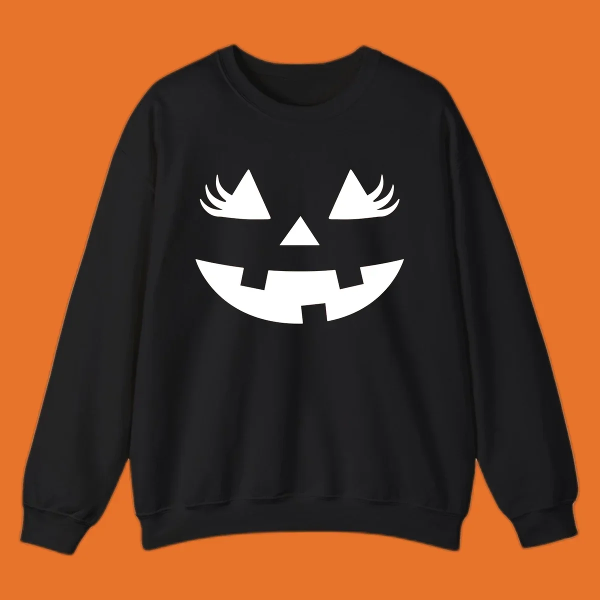 Jack o' lantern face with triangle eyes, nose, and jagged smile, featuring eyelashes.