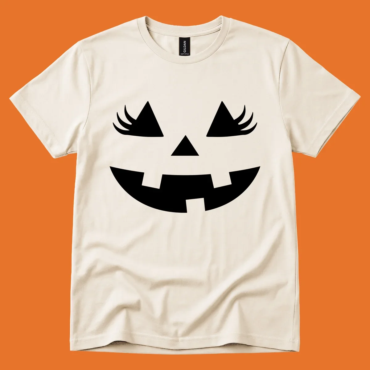 Jack o' lantern face with triangle eyes, nose, and jagged smile, featuring eyelashes.