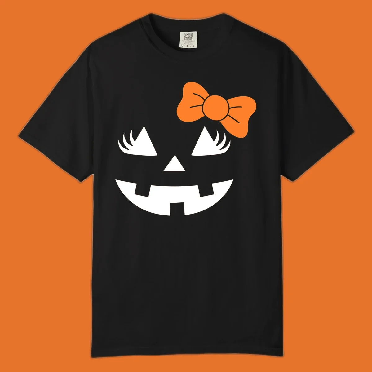 Cute halloween pumpkin face with an orange bow graphic