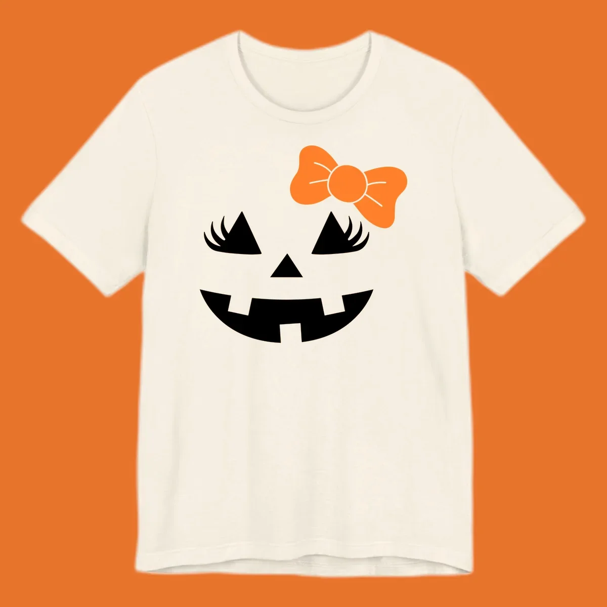 Cute halloween pumpkin face with an orange bow graphic