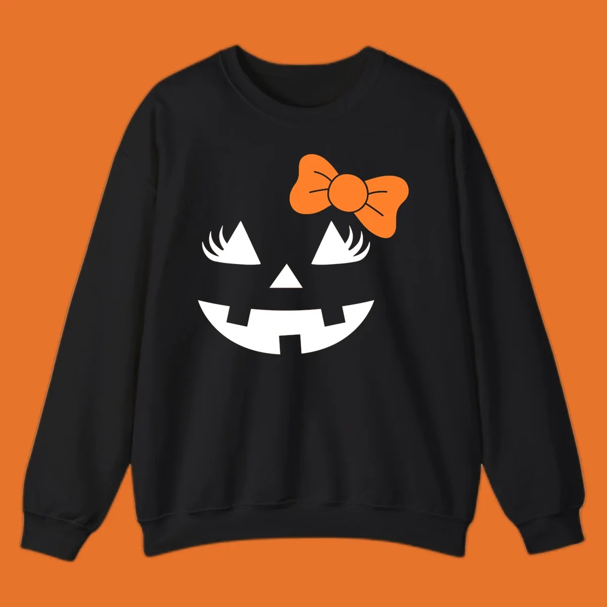 Cute halloween pumpkin face with an orange bow graphic