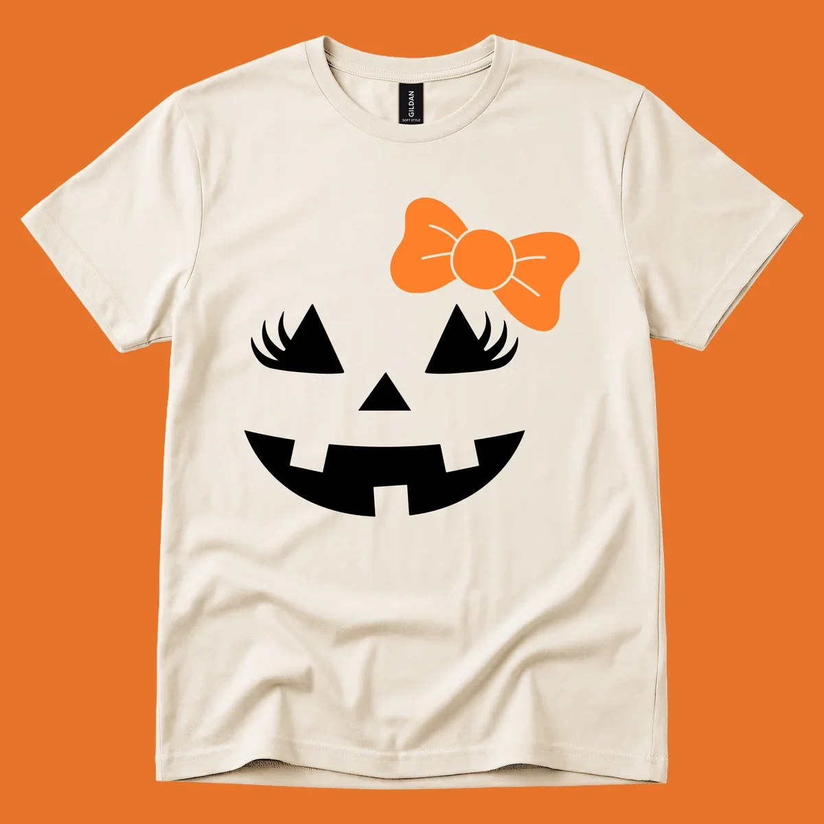Cute halloween pumpkin face with an orange bow graphic