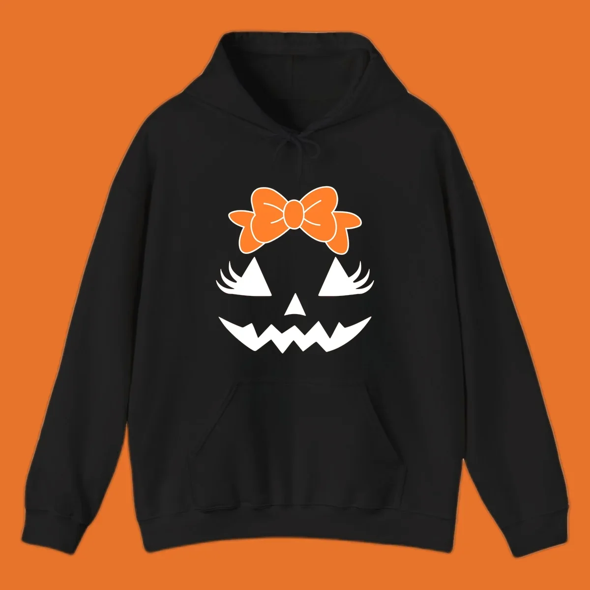 Cute pumpkin face graphic with orange bow, triangle eyes, nose, and jagged smile.