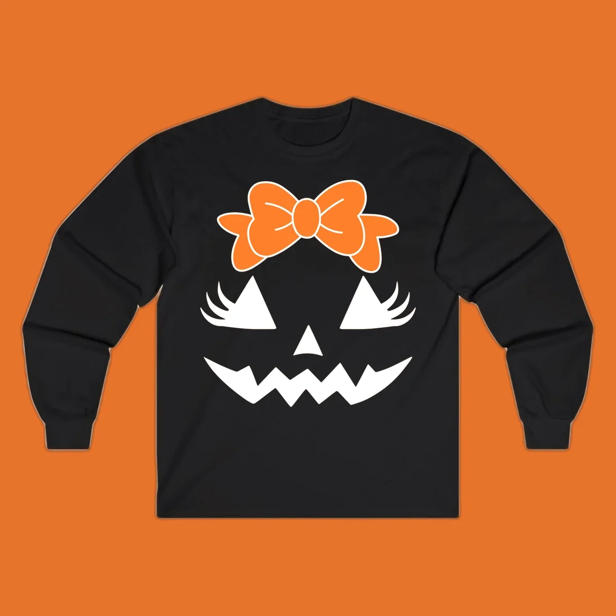 Cute pumpkin face graphic with orange bow, triangle eyes, nose, and jagged smile.