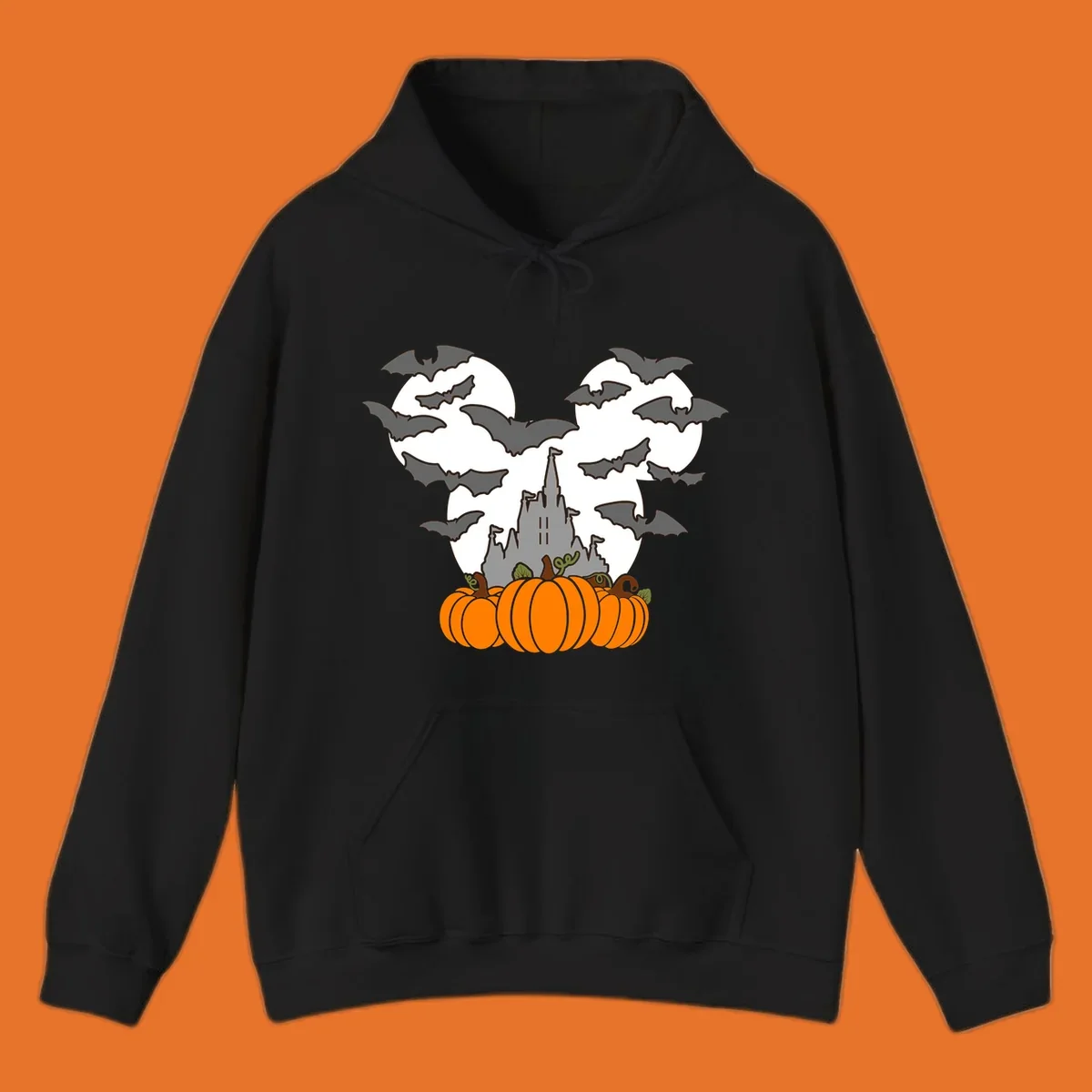 Halloween castle with bats and pumpkins against a Mickey Mouse ears moon graphic.
