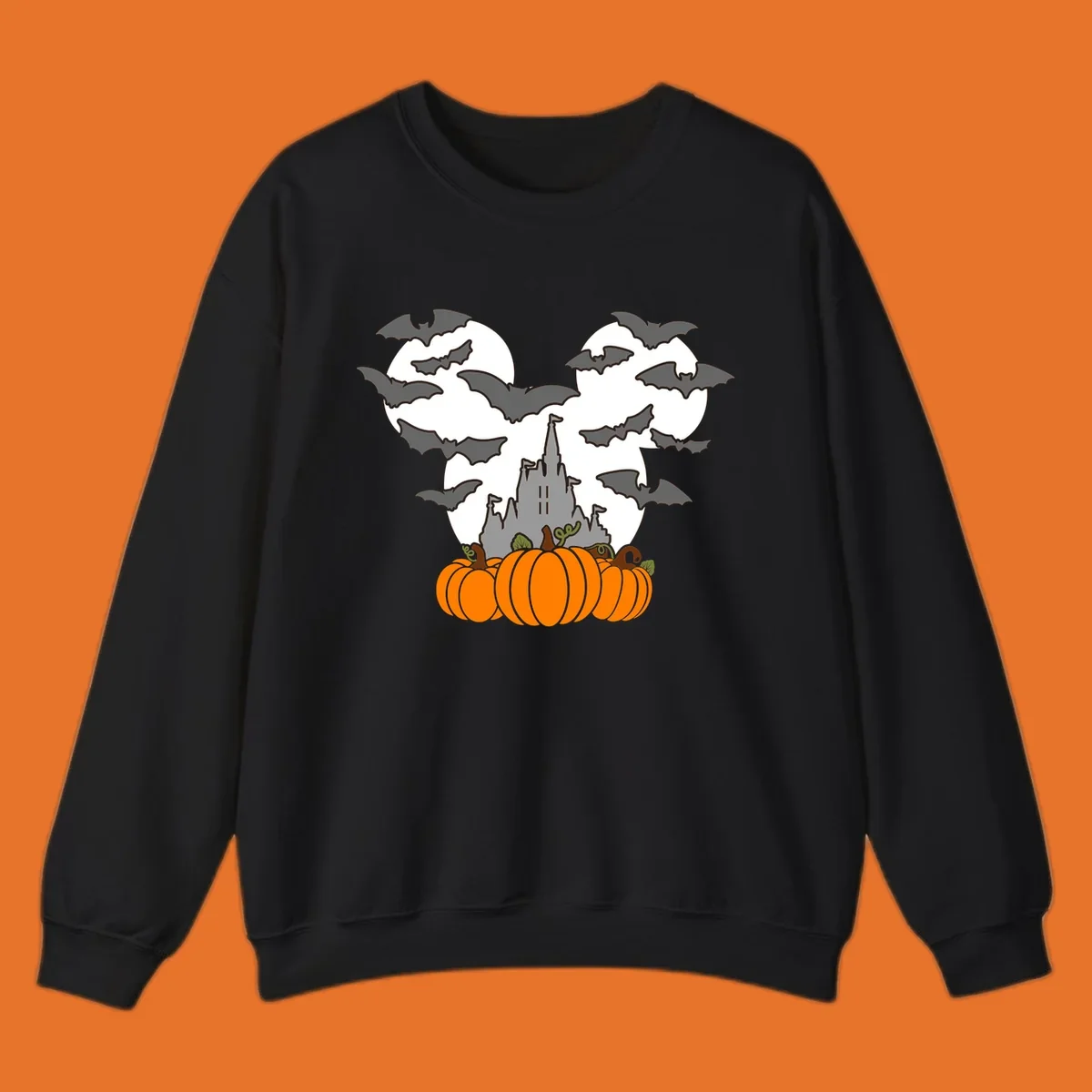 Halloween castle with bats and pumpkins against a Mickey Mouse ears moon graphic.