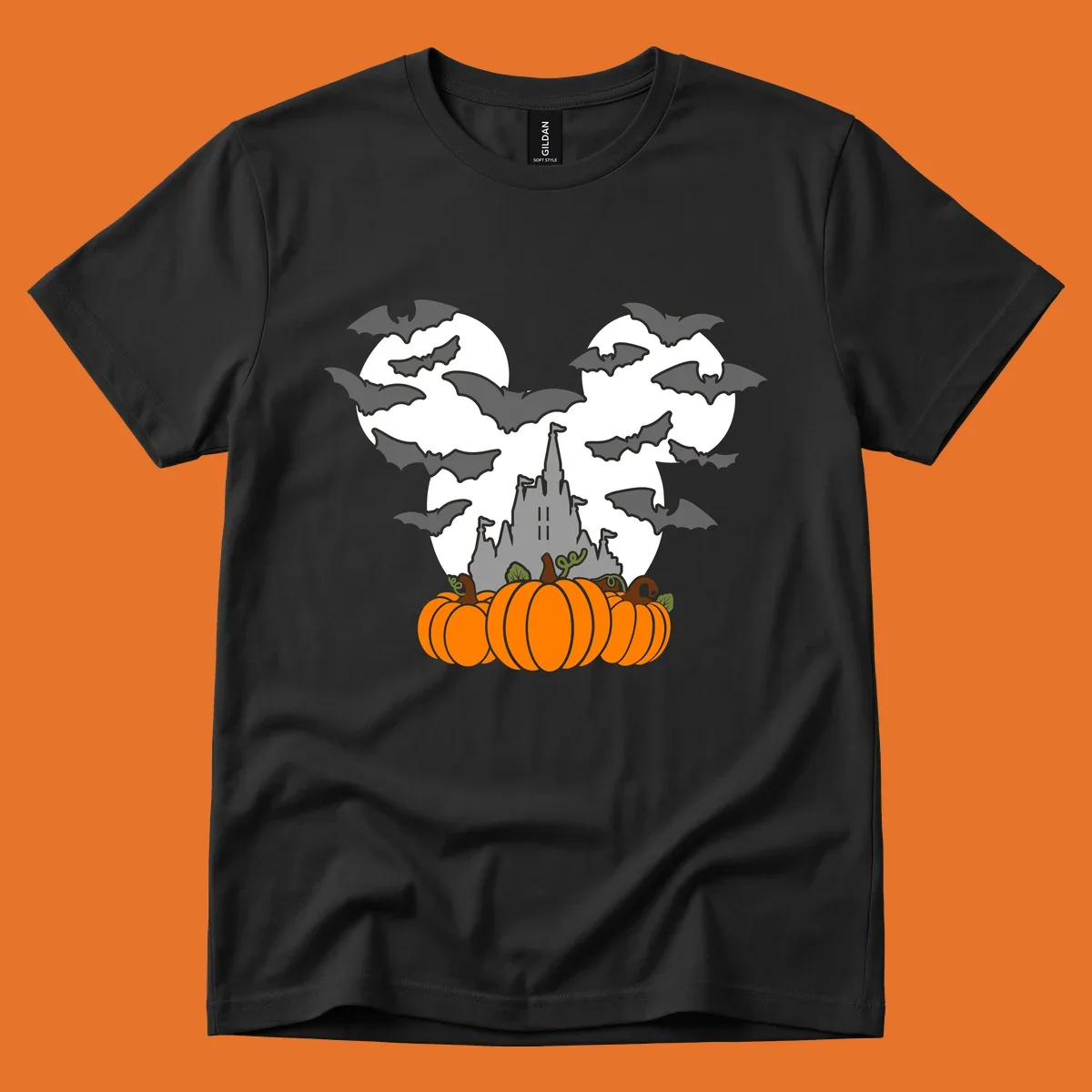 Halloween castle with bats and pumpkins against a Mickey Mouse ears moon graphic.