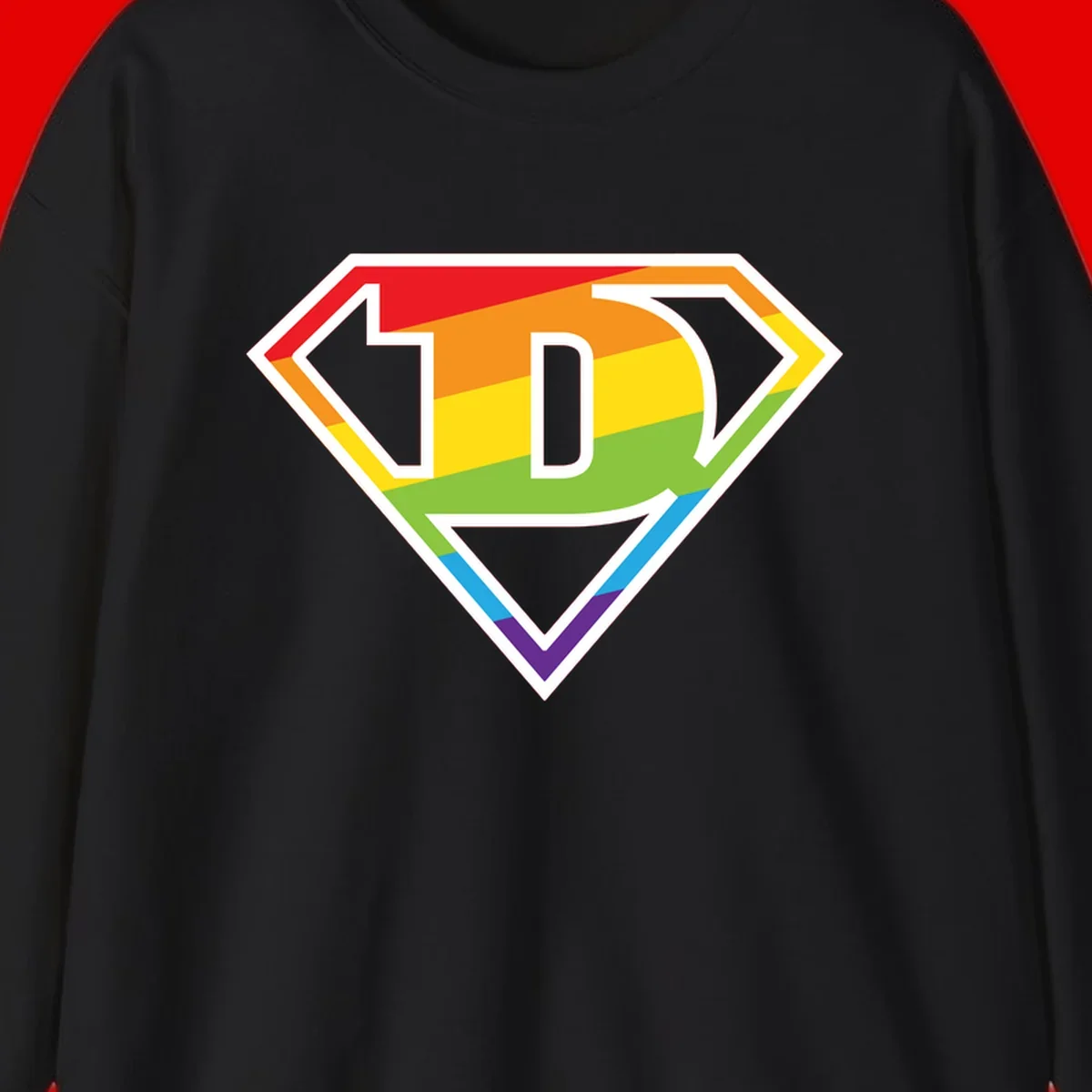 Rainbow pride shield with letter D centered, featuring red, orange, yellow, green, blue, and purple horizontal stripes with white chevron borders