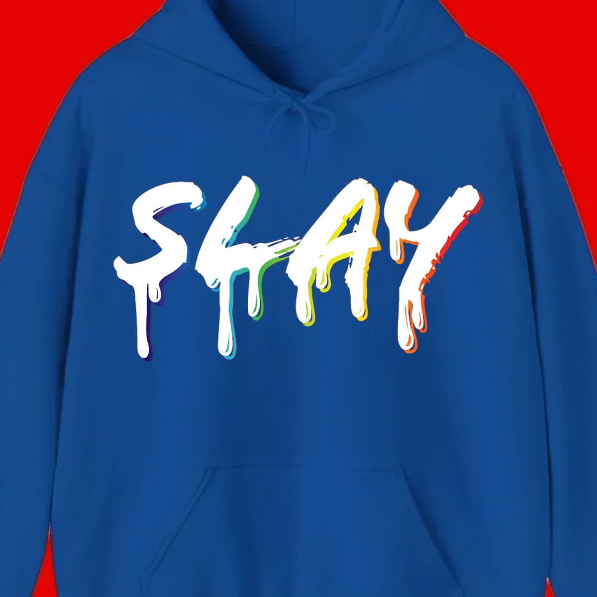 The word STAY in white letters with rainbow pride-colored paint drips flowing downward, featuring blue, teal, green, yellow, orange, and red colors on gray background