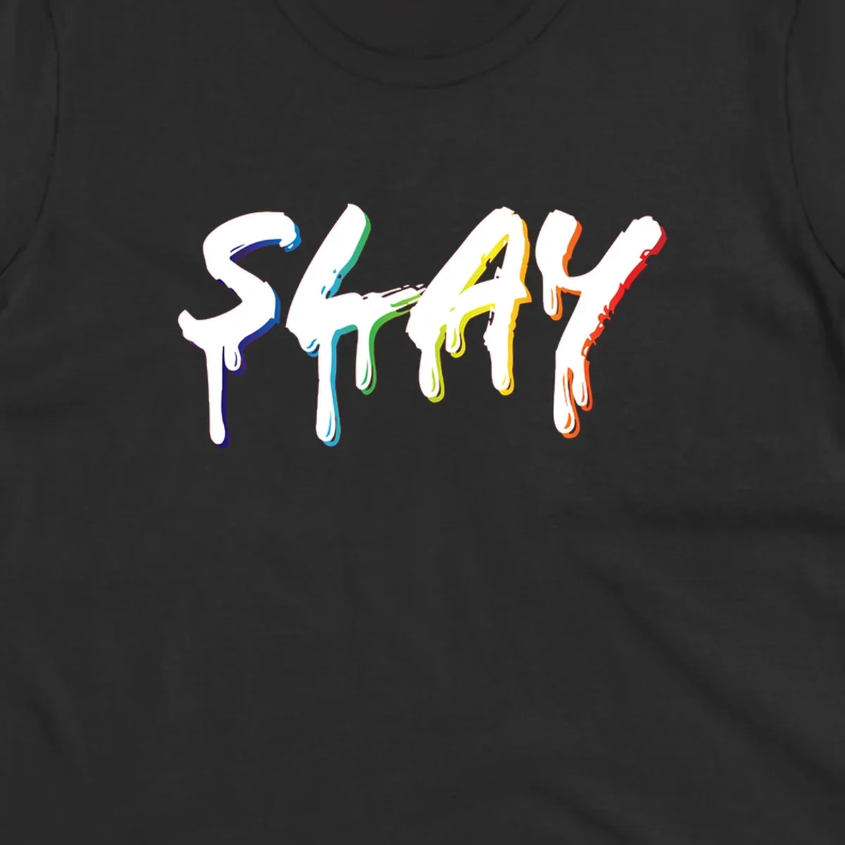 The word STAY in white letters with rainbow pride-colored paint drips flowing downward, featuring blue, teal, green, yellow, orange, and red colors on gray background