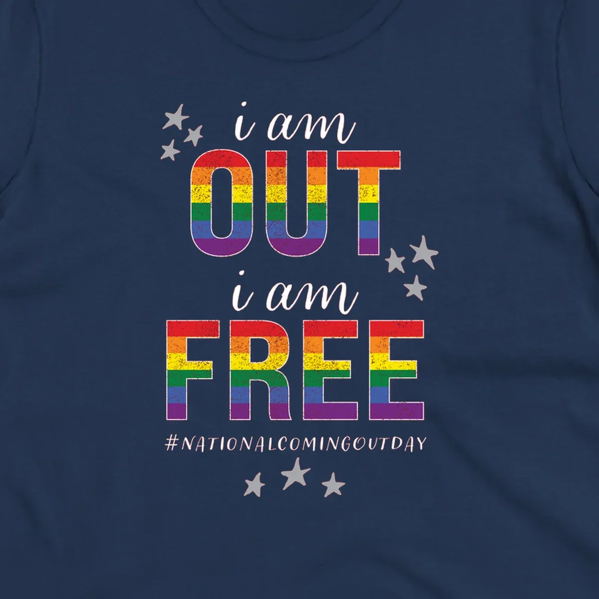 Rainbow-striped letters spelling 'i am OUT i am FREE' with decorative stars on gray background celebrating National Coming Out Day pride.