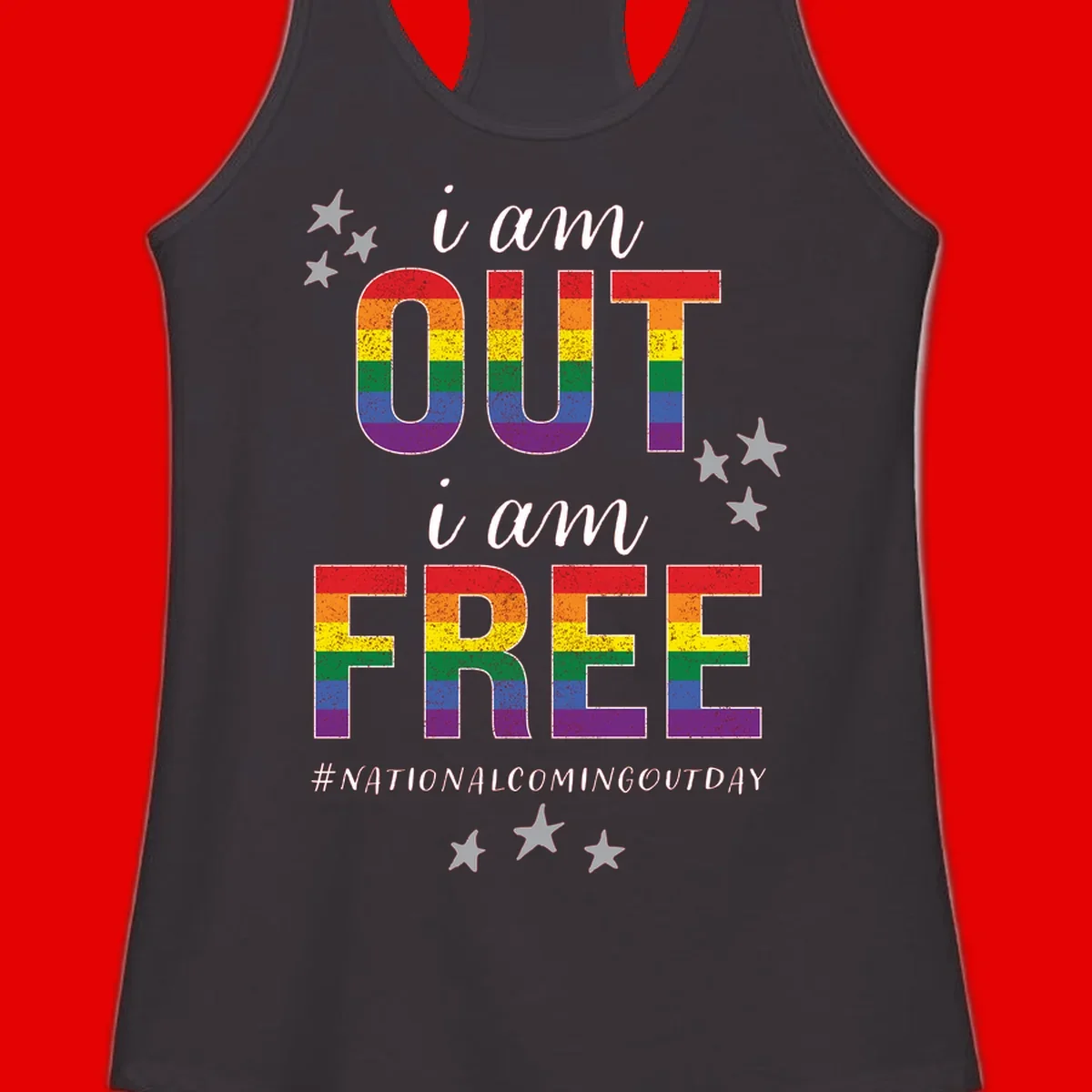 Rainbow-striped letters spelling 'i am OUT i am FREE' with decorative stars on gray background celebrating National Coming Out Day pride.