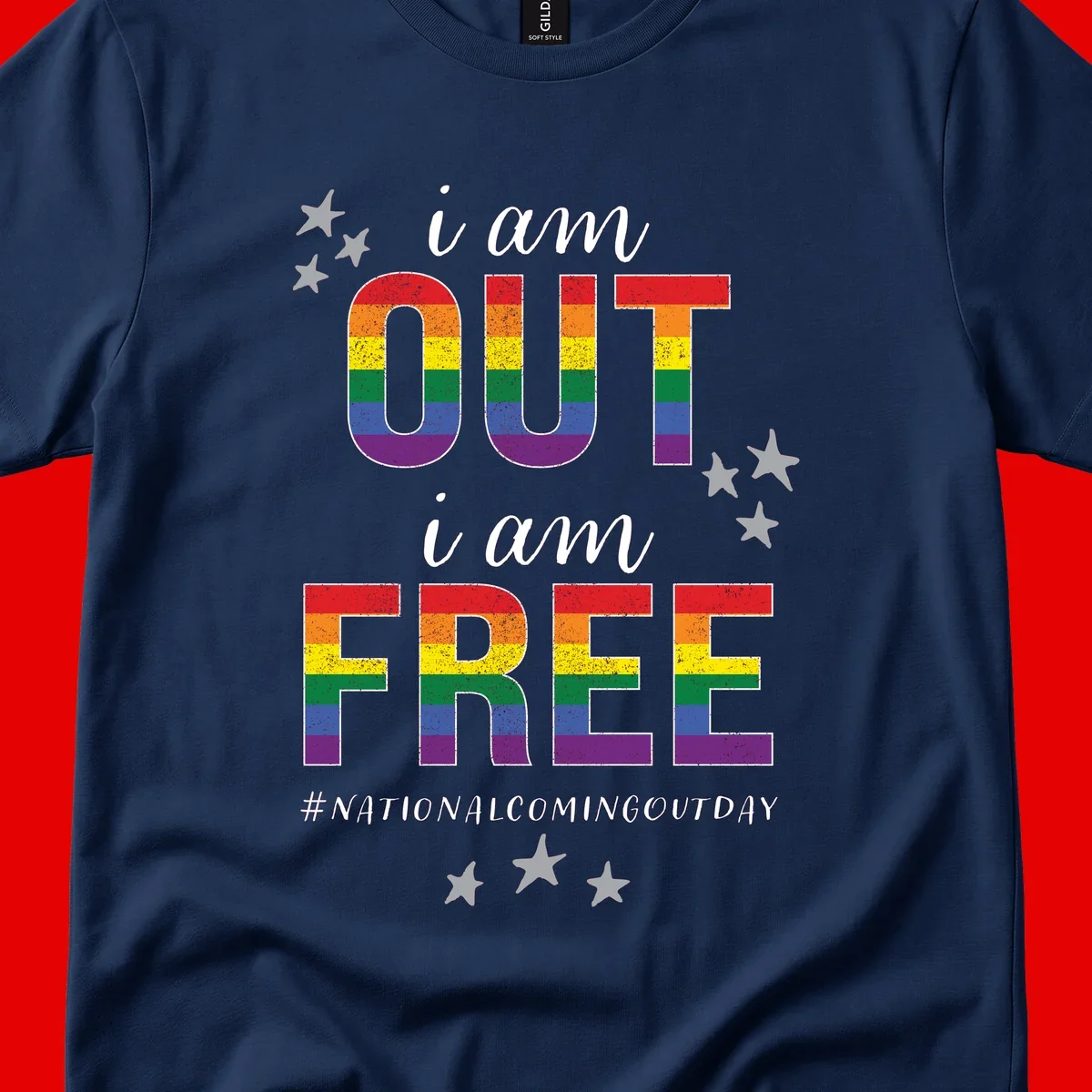 Rainbow-striped letters spelling 'i am OUT i am FREE' with decorative stars on gray background celebrating National Coming Out Day pride.