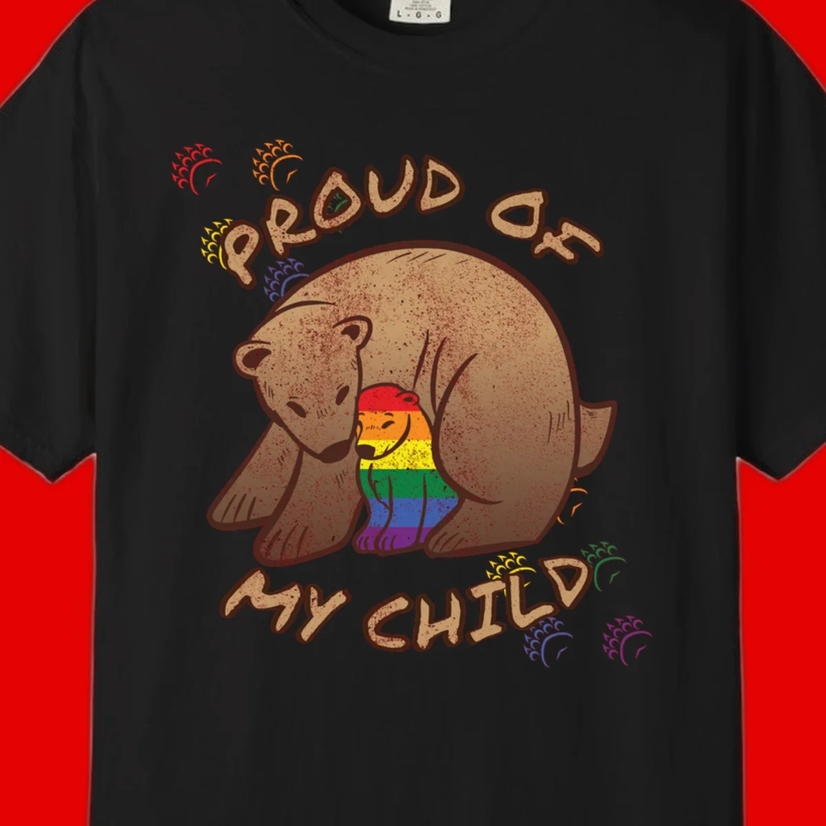 Brown bear proudly displaying rainbow pride colors with 'Proud As Shit' text and decorative bursts