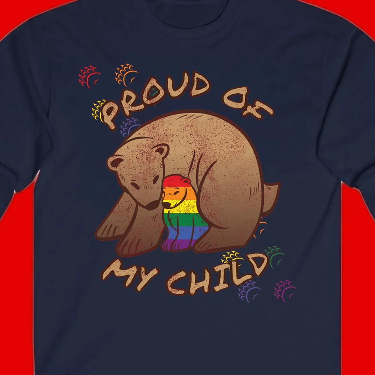 Brown bear proudly displaying rainbow pride colors with 'Proud As Shit' text and decorative bursts