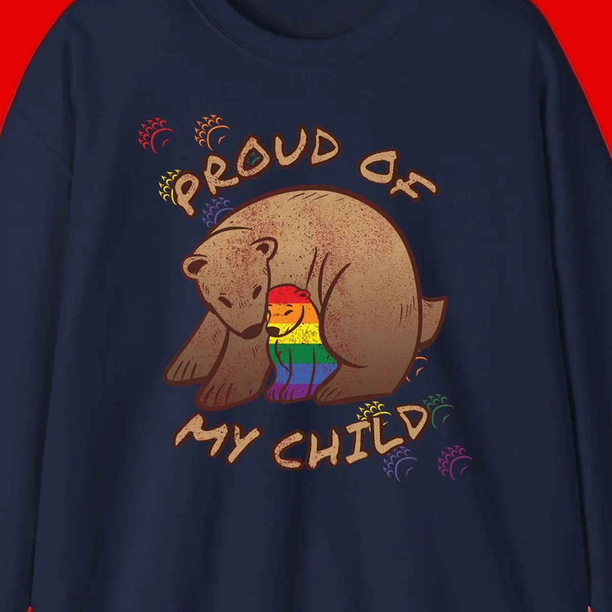 Brown bear proudly displaying rainbow pride colors with 'Proud As Shit' text and decorative bursts