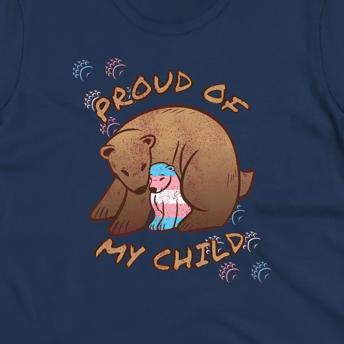 Brown bear holding a cub with blue, pink and white stripes, surrounded by 'Proud As My Chubby' text and decorative wave designs celebrating transgender pride