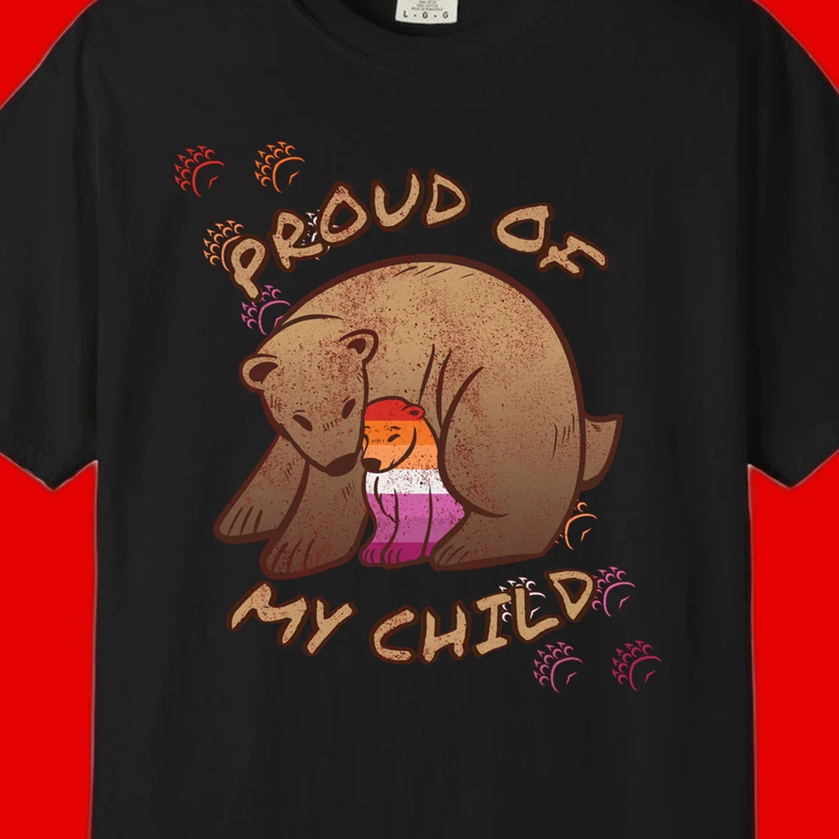 Brown bear proudly holding a sushi roll with pride flag stripes, surrounded by sparkles and text reading 'PROUD AS MY SUSHI'