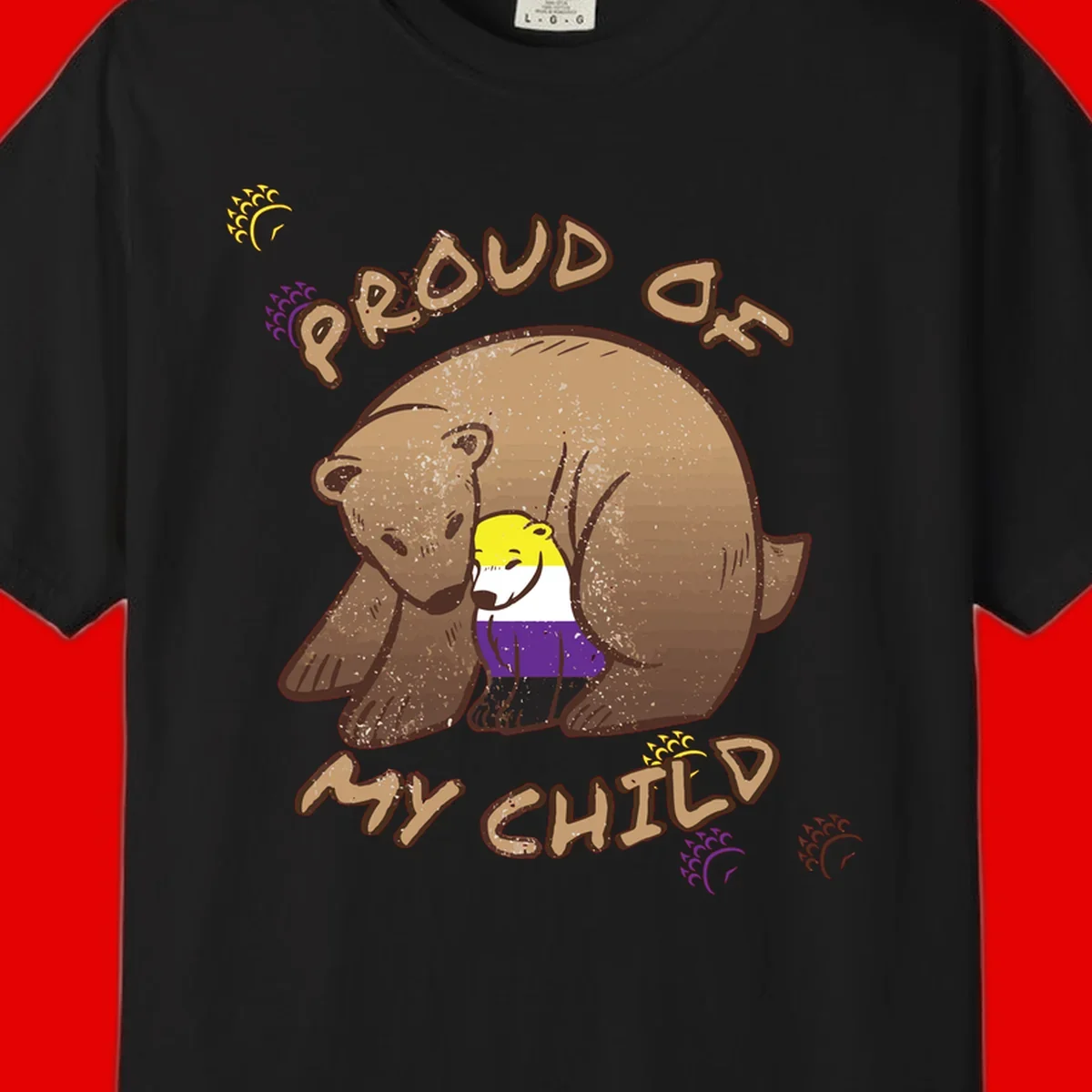 Illustration of a large brown bear's head in profile containing a small figure wearing pride flag colors, with text reading 'Proud As Child'