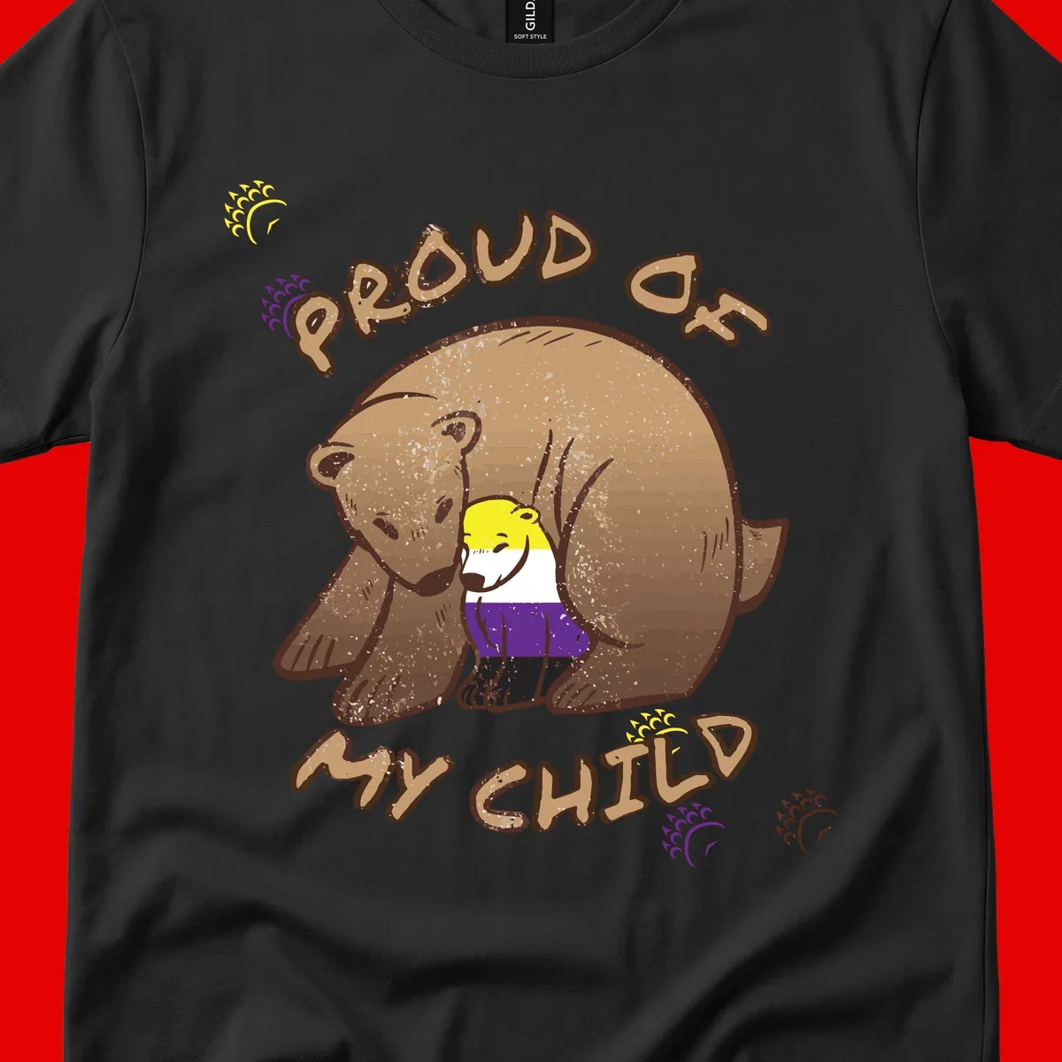 Illustration of a large brown bear's head in profile containing a small figure wearing pride flag colors, with text reading 'Proud As Child'