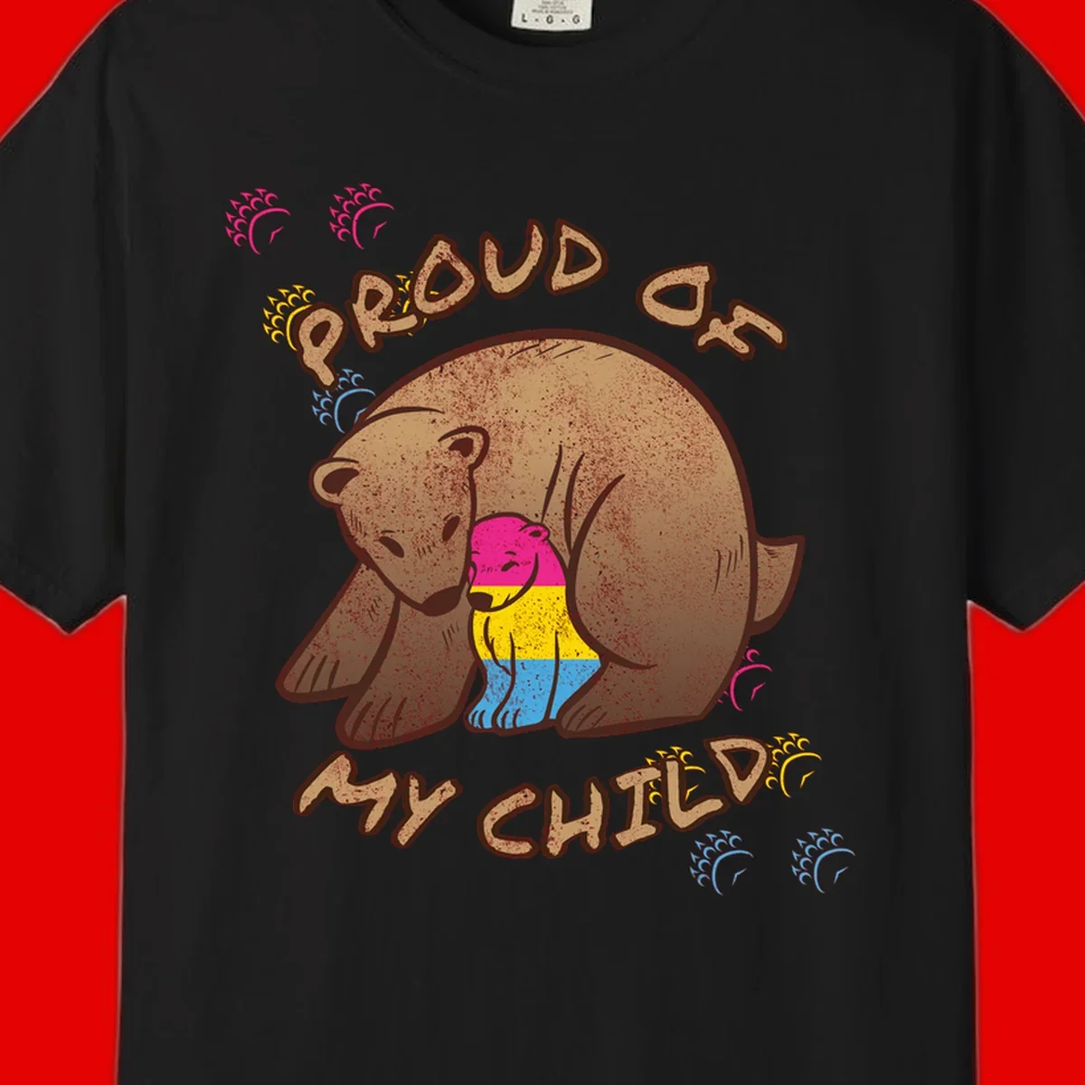 Large bear proudly hugging a smaller bear cub wearing a pride flag shirt, with text reading 'Proud As My Child'