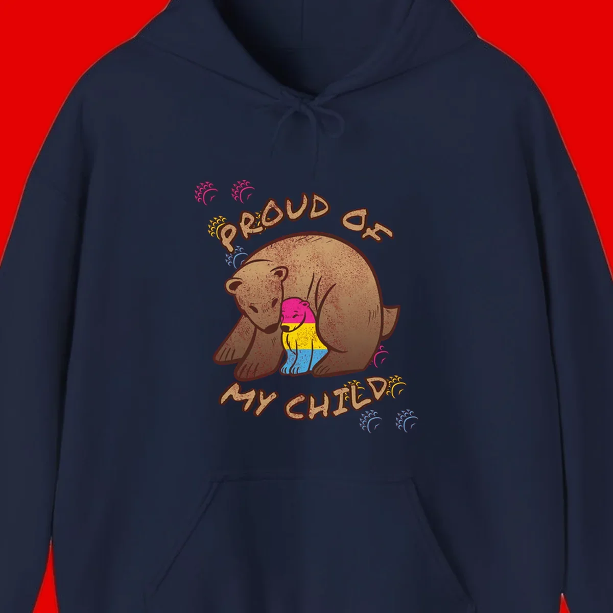 Large bear proudly hugging a smaller bear cub wearing a pride flag shirt, with text reading 'Proud As My Child'